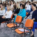 Nauczycielki oglądają przedstawienie_ siedzą na środku sali gimnastycznej.jpg