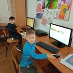 Dwoje uczniów prezentuje wykonane przez siebie prace na komputerze.jpg