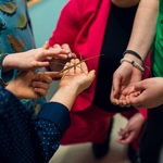 Jeden z małych gości trzyma na dłoni patyczaka_ wokół niego stoją uczniowie i nauczycielka..jpg