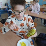 Chłopiec maluje szyszkę na żółto.jpg