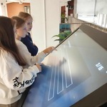 Trzy uczennice rozwiązują test wiedzy o Sybirze na tablicy multimedialnej.jpg